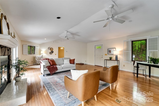 362 Cowan Valley Ests, Sylva, NC 28779 - living area with lofted ceiling, ceiling fan, a glass covered fireplace, light wood-type flooring, and baseboards