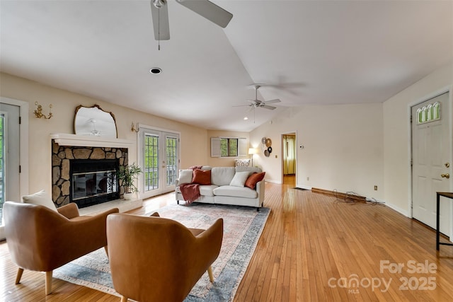 362 Cowan Valley Ests, Sylva, NC 28779 - living area with a ceiling fan, lofted ceiling, a stone fireplace, and light wood-type flooring