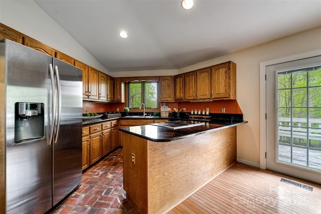 362 Cowan Valley Ests, Sylva, NC 28779 - kitchen featuring stainless steel appliances, a sink, brown cabinets, dark countertops, and vaulted ceiling