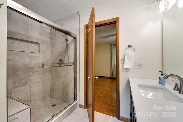 362 Cowan Valley Ests, Sylva, NC 28779 - full bathroom with a textured ceiling, a stall shower, vanity, baseboards, and crown molding