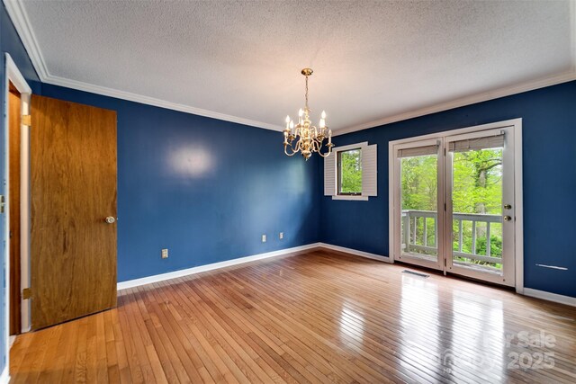 362 Cowan Valley Ests, Sylva, NC 28779 - spare room with a textured ceiling, a chandelier, baseboards, hardwood / wood-style floors, and crown molding