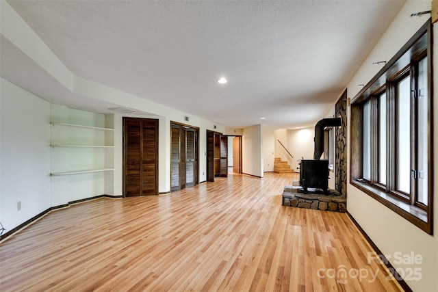 362 Cowan Valley Ests, Sylva, NC 28779 - unfurnished living room featuring light wood finished floors, baseboards, stairs, recessed lighting, and built in features