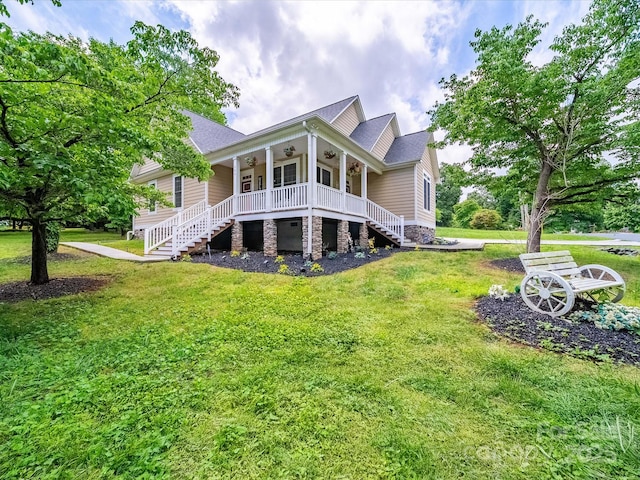 back of house with stairs, a ceiling fan, a yard, and covered porch