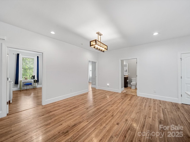 unfurnished living room with light wood-style flooring, baseboards, and recessed lighting