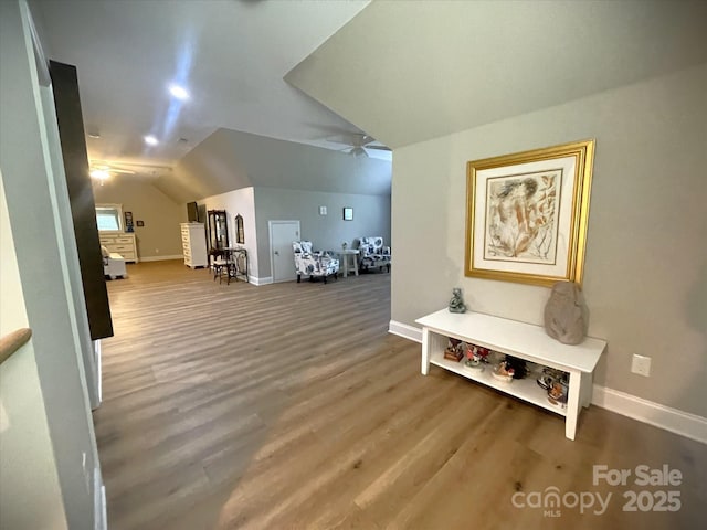 bonus room featuring vaulted ceiling, a ceiling fan, wood finished floors, and baseboards