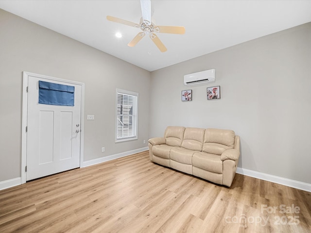 living area with an AC wall unit, light wood-style floors, baseboards, and recessed lighting