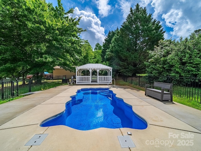 view of pool with a gazebo, a patio area, and fence
