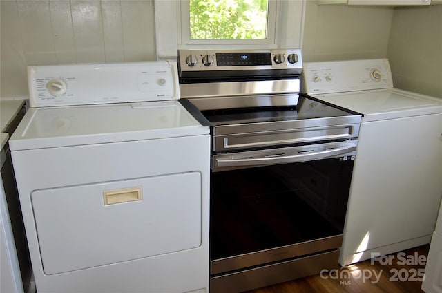 laundry room with wood finished floors, laundry area, and washer and clothes dryer