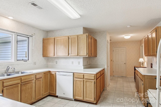 208 Dartcrest Dr, Hendersonville, NC 28792 - kitchen with white dishwasher, a sink, a textured ceiling, wallpapered walls, and visible vents