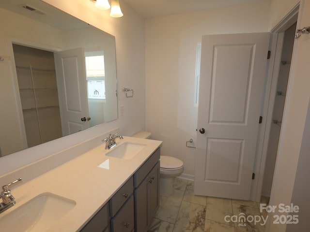 1119 Overbrook Pl, Wingate, NC 28174 - full bath featuring marble finish floors, toilet, and double vanity