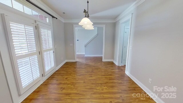 unfurnished dining area with crown molding, baseboards, and a healthy amount of sunlight