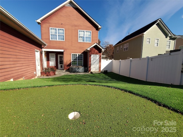rear view of property with a lawn, fence, and a patio area