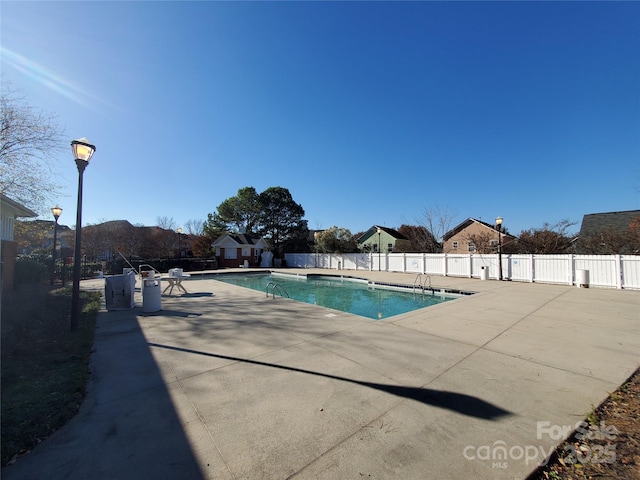 pool featuring a patio area and fence
