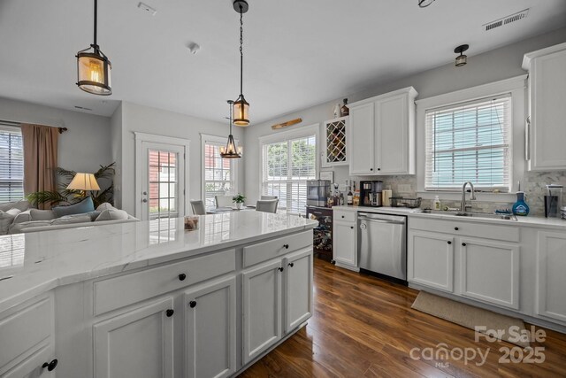 1508 Peaceful Way Dr, Charlotte, NC 28206 - kitchen featuring dishwasher, a sink, dark wood-type flooring, and backsplash