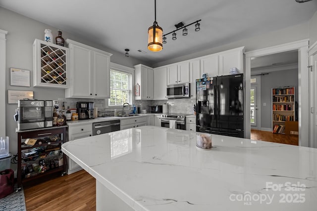 1508 Peaceful Way Dr, Charlotte, NC 28206 - kitchen featuring stainless steel appliances, a sink, wood finished floors, and white cabinets