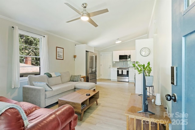 living area with vaulted ceiling, light wood-type flooring, crown molding, and a ceiling fan