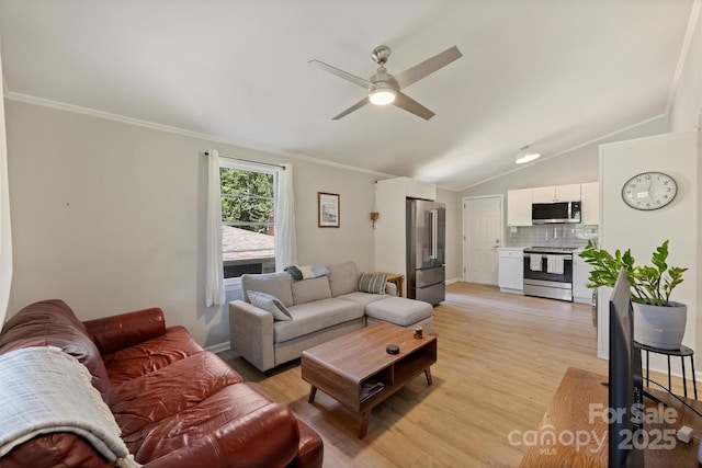 living area featuring vaulted ceiling, baseboards, light wood-style floors, ceiling fan, and crown molding