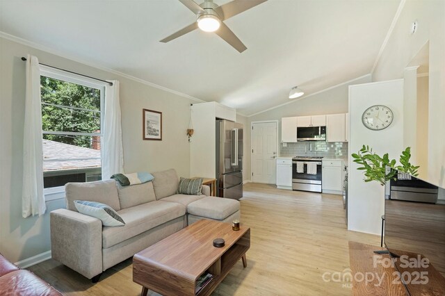 living area with ceiling fan, crown molding, and light wood-style flooring