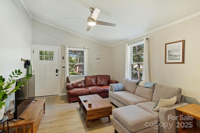 living room featuring ceiling fan, vaulted ceiling, a healthy amount of sunlight, and light wood finished floors
