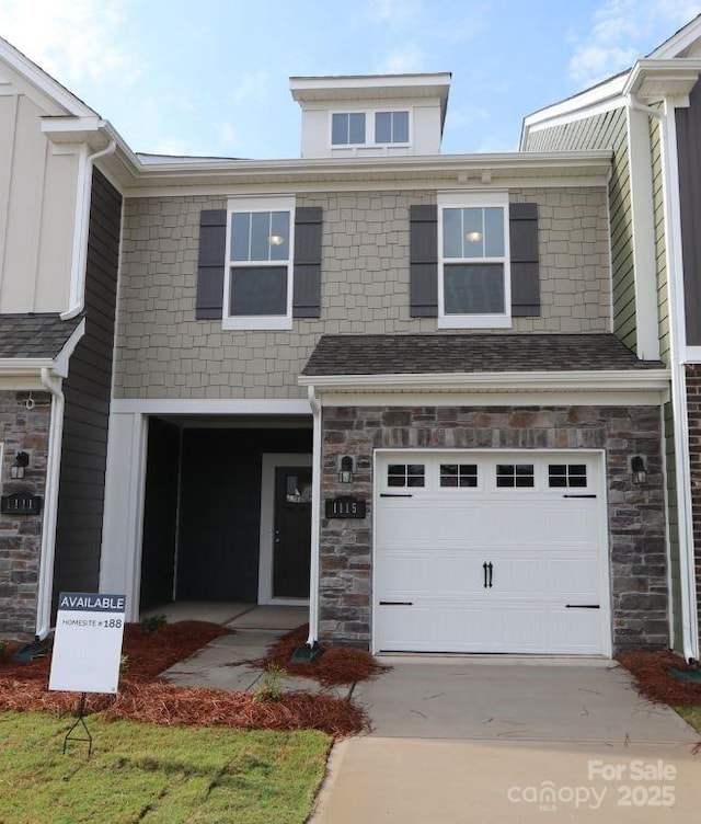 1115 Overbrook Pl, Wingate, NC 28174 - view of front facade featuring stone siding, an attached garage, and driveway