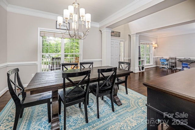 141 Culpeze Rd, Mooresville, NC 28117 - dining room featuring crown molding, decorative columns, wood finished floors, a chandelier, and baseboards