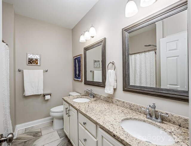141 Culpeze Rd, Mooresville, NC 28117 - bathroom with baseboards, toilet, double vanity, and marble look tile flooring