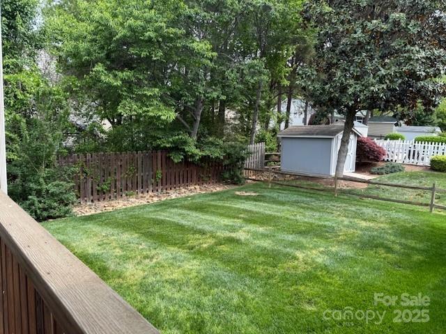 134 Walmsley Pl, Mooresville, NC 28117 - view of yard with a storage unit, an outbuilding, and a fenced backyard
