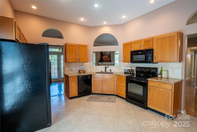 134 Walmsley Pl, Mooresville, NC 28117 - kitchen featuring light stone countertops, recessed lighting, black appliances, backsplash, and a sink