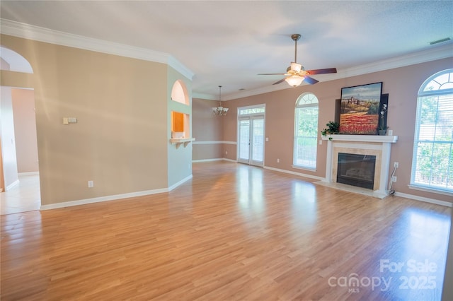 134 Walmsley Pl, Mooresville, NC 28117 - unfurnished living room featuring a tiled fireplace, visible vents, ceiling fan with notable chandelier, and baseboards