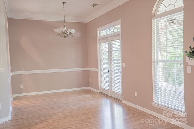 134 Walmsley Pl, Mooresville, NC 28117 - empty room featuring visible vents, a notable chandelier, baseboards, and light wood-style floors