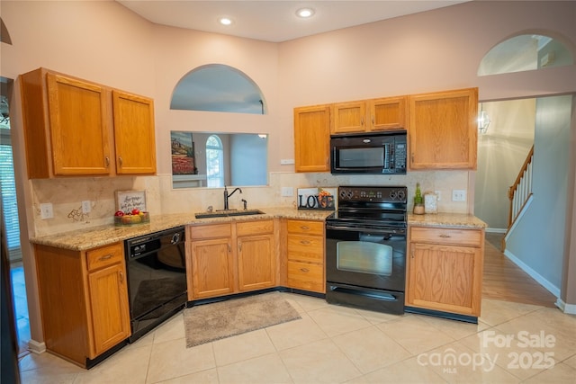 134 Walmsley Pl, Mooresville, NC 28117 - kitchen featuring black appliances, backsplash, light stone counters, and a sink