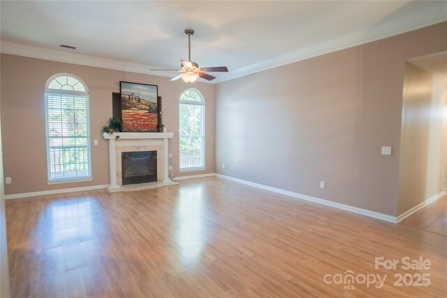 134 Walmsley Pl, Mooresville, NC 28117 - unfurnished living room with a premium fireplace, light wood-type flooring, a ceiling fan, and ornamental molding