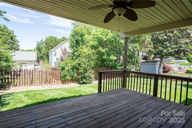 134 Walmsley Pl, Mooresville, NC 28117 - wooden terrace featuring a storage unit, a fenced backyard, a ceiling fan, and an outbuilding