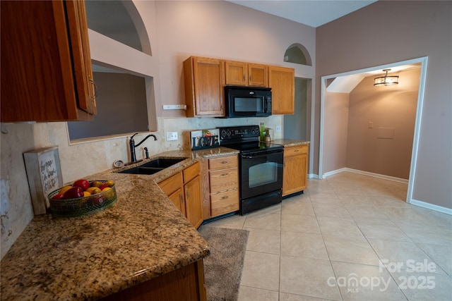 134 Walmsley Pl, Mooresville, NC 28117 - kitchen with brown cabinets, a sink, stone countertops, black appliances, and light tile patterned flooring