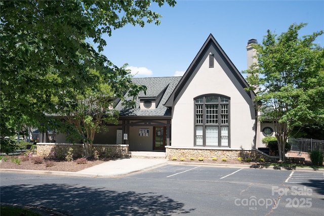 134 Walmsley Pl, Mooresville, NC 28117 - view of front of home featuring fence, stucco siding, uncovered parking, and stone siding