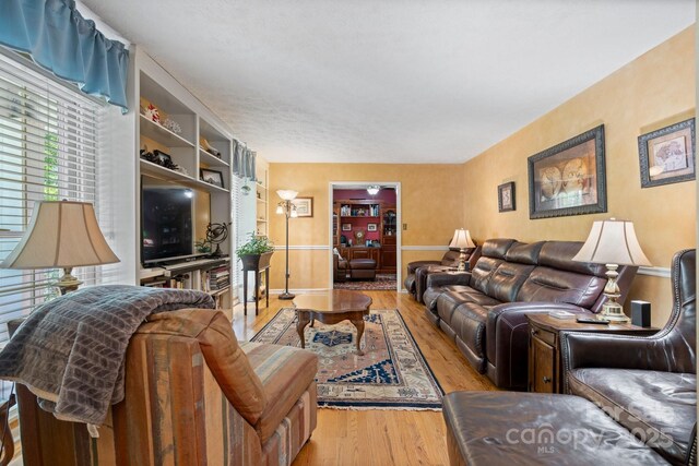 living area featuring baseboards and wood finished floors