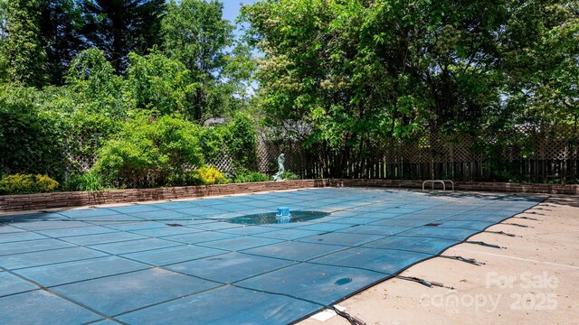 view of pool featuring fence