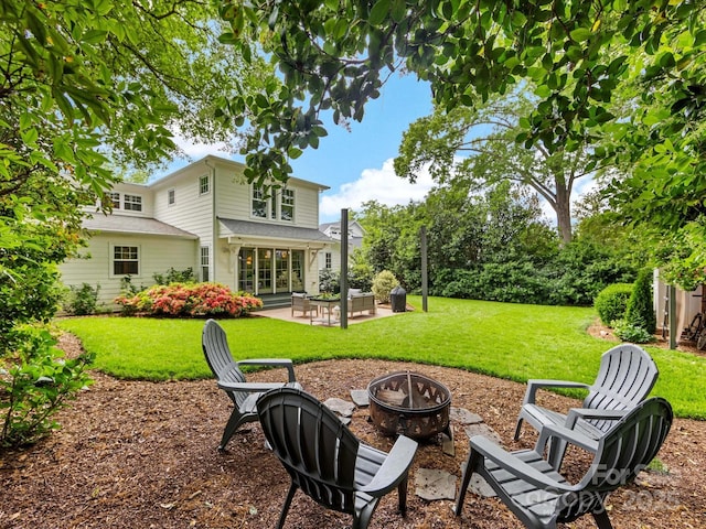 view of yard featuring a fire pit and a patio