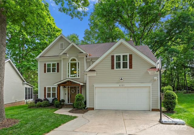 traditional-style home with driveway, a shingled roof, and a front lawn