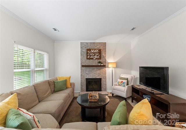 living room featuring ornamental molding, a brick fireplace, and visible vents