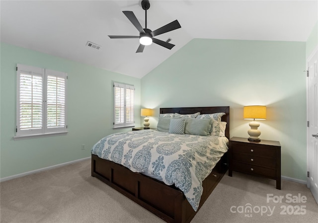 bedroom with vaulted ceiling, baseboards, visible vents, light colored carpet, and a ceiling fan