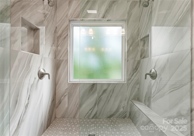 full bath with a marble finish shower