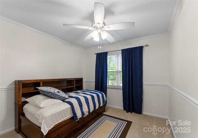carpeted bedroom featuring baseboards, ceiling fan, and crown molding