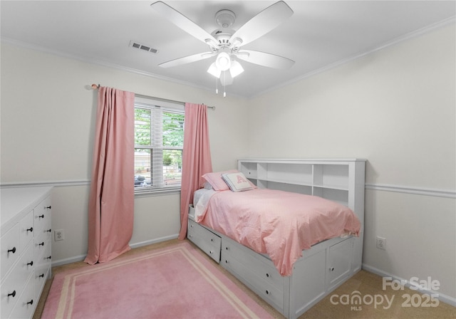 bedroom with a ceiling fan, light colored carpet, baseboards, ornamental molding, and visible vents