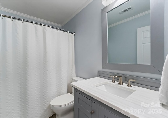 bathroom featuring visible vents, crown molding, vanity, and toilet