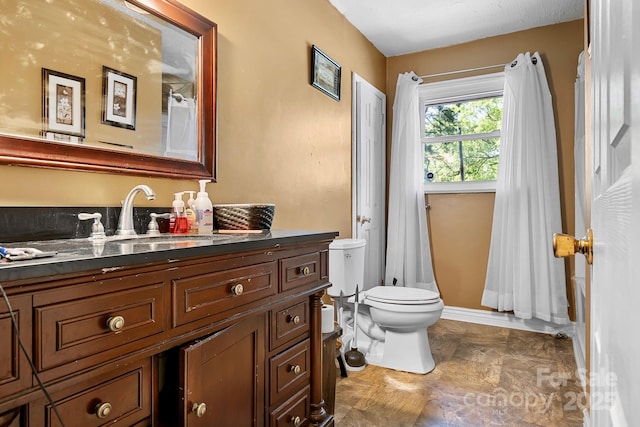 3265 W Innes St, Salisbury, NC 28144 - bathroom with toilet, stone finish flooring, and vanity