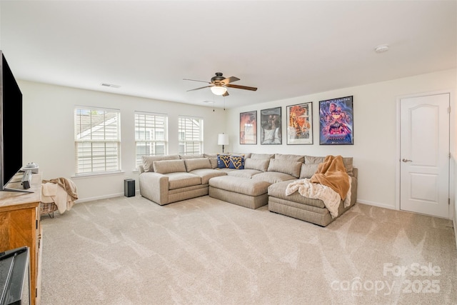living area with carpet, visible vents, baseboards, and ceiling fan