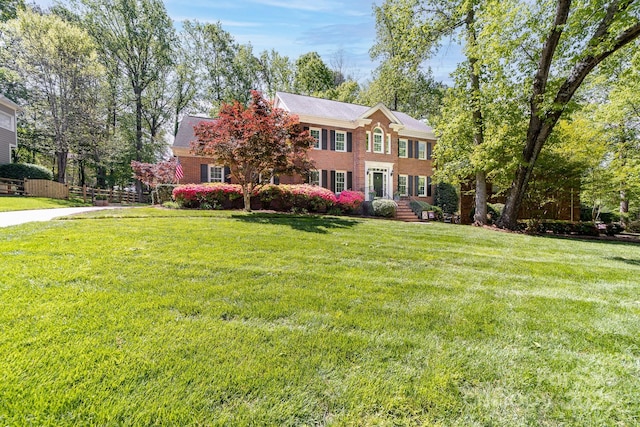 14812 Stonegreen Ln, Huntersville, NC 28078 - colonial house with brick siding, a front lawn, and fence