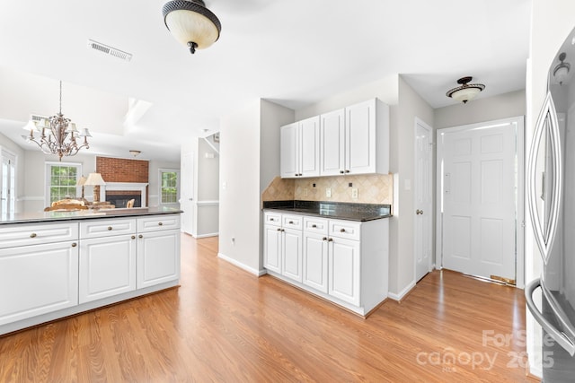 14812 Stonegreen Ln, Huntersville, NC 28078 - kitchen with dark countertops, light wood-style flooring, and freestanding refrigerator