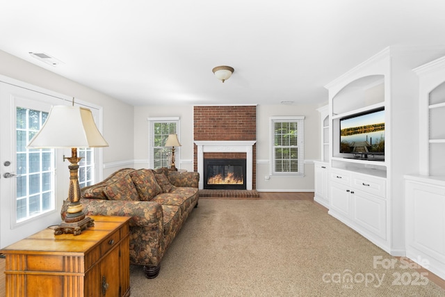 14812 Stonegreen Ln, Huntersville, NC 28078 - living room with visible vents, a brick fireplace, and light colored carpet
